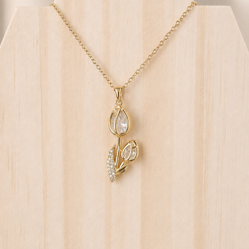 A delicate gold-tone tulip necklace made from 304 stainless steel and finished with clear sparkling details. Part of the Neréa Anthi Curated Collection.