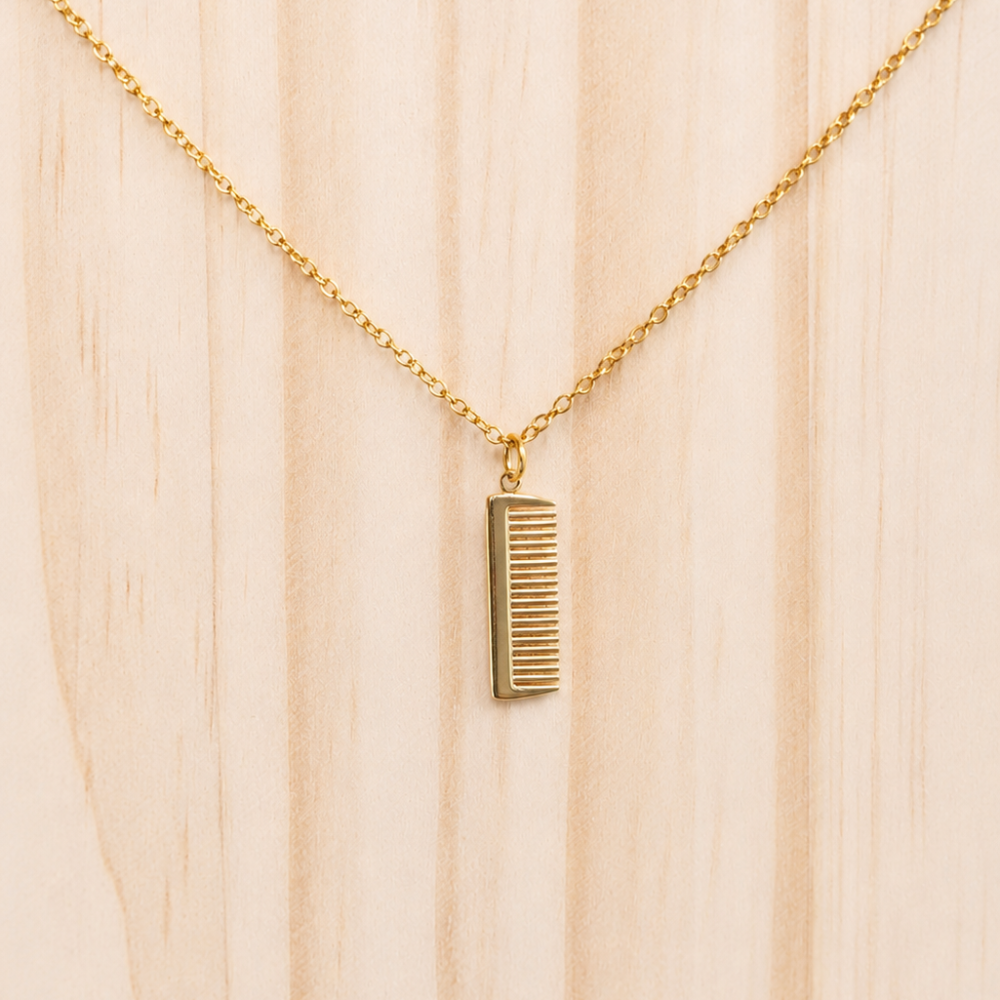 A delicate miniature comb necklace made from 14k gold plated stainless steel. A playful everyday piece from the Neréa Anthi Curated Collection.