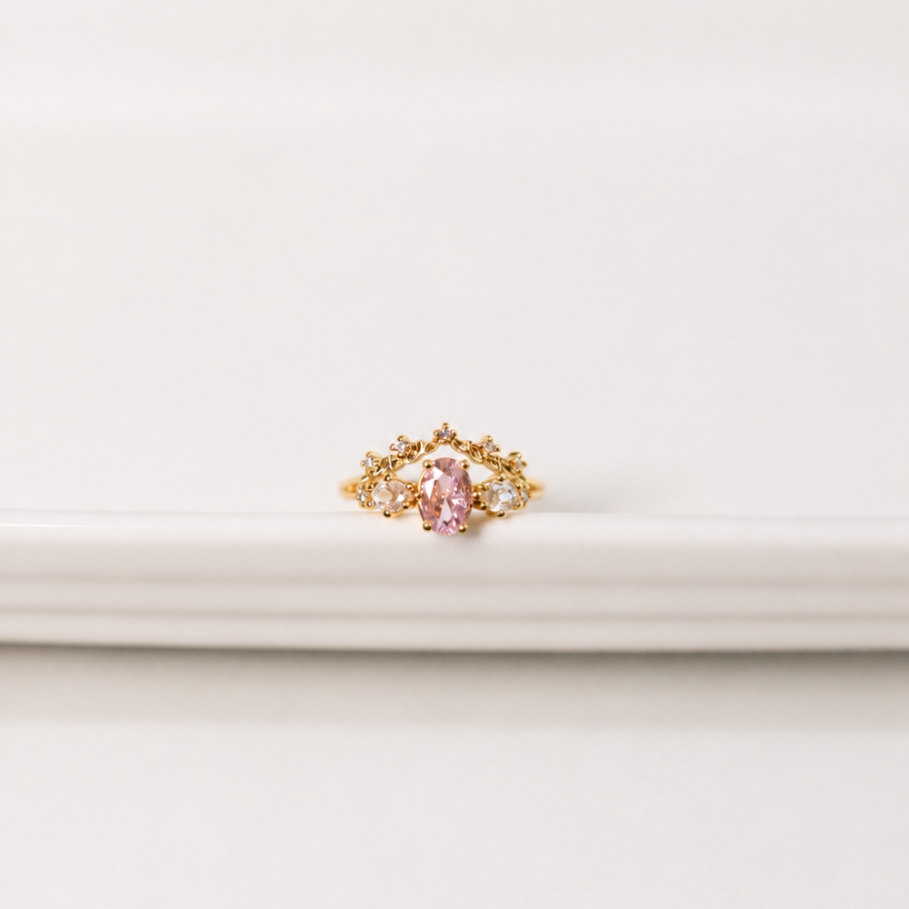 A delicate adjustable gold-plated ring with a blush pink centre zircon and clear sparkling details. Part of the Neréa Anthi Curated Collection.