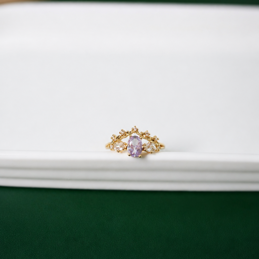 A delicate adjustable gold-plated ring with a lavender centre zircon, clear stones, and floral details. Part of the Neréa Anthi Curated Collection.