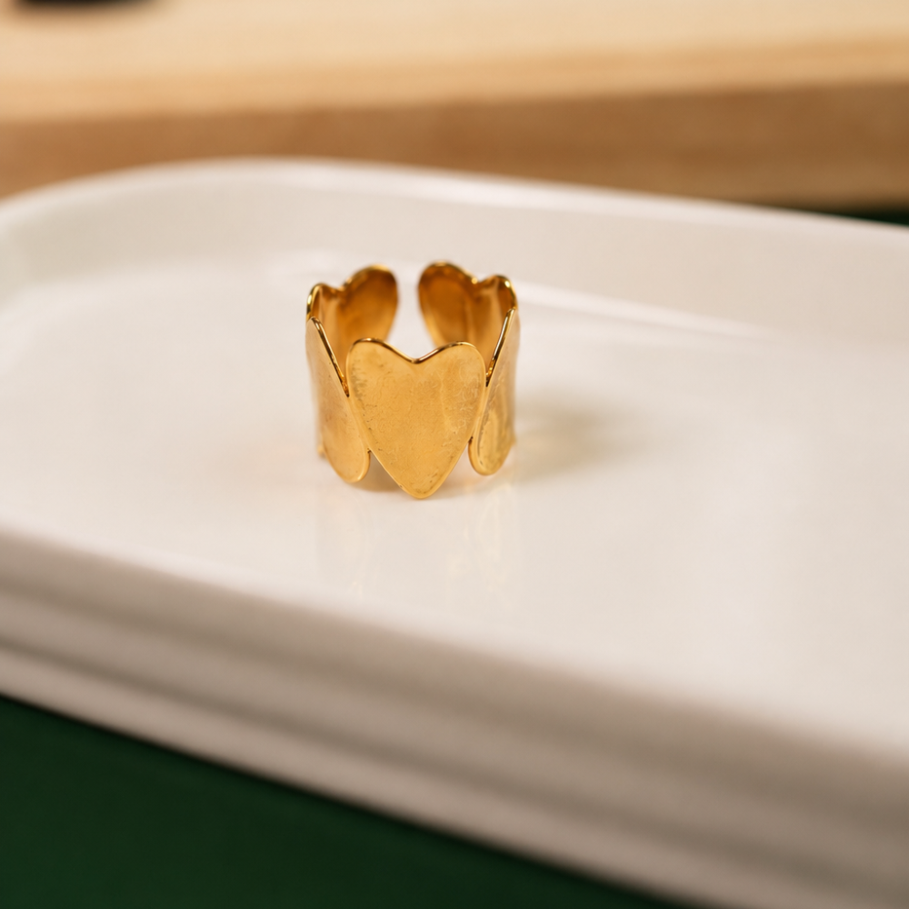 A bold adjustable ring made from 14k gold-plated stainless steel and formed from softly sculpted hearts. Part of the Neréa Anthi Curated Collection.